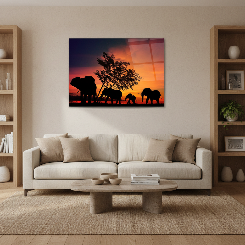 Horizontal glass wall art featuring a family of elephants at sunset displayed in a warm family living room