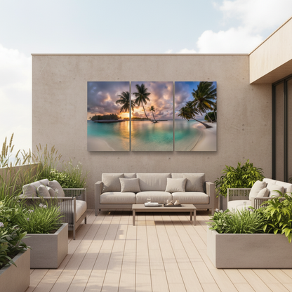 Tropical beach sunset triptych glass wall art on a luxury terrace with warm concrete walls and outdoor lounge seating